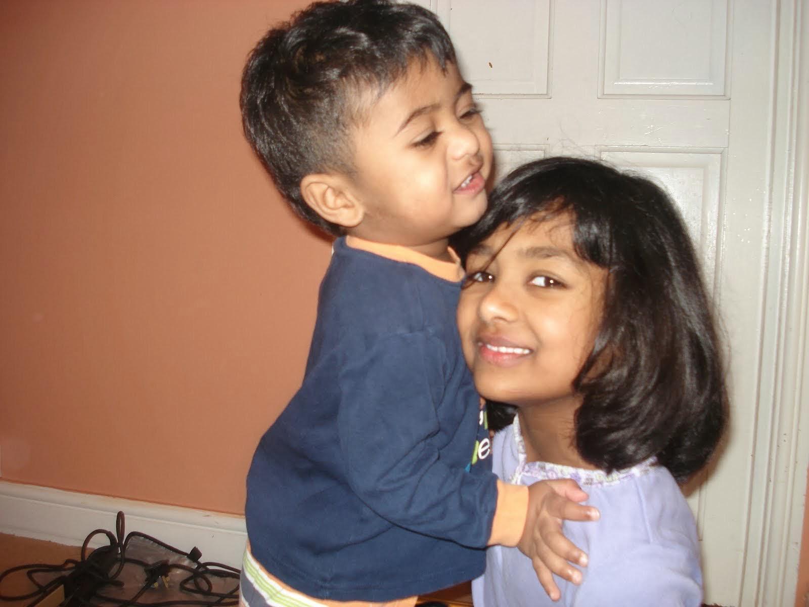 Young Kaysh hugging her younger sibling